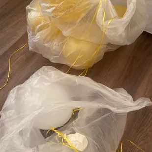 Deflated balloons. One of multiple and none are floating but yet they are "helium"??