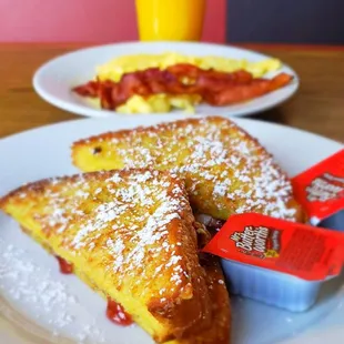 a plate of french toast and a cup of orange juice