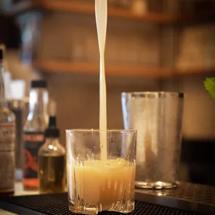 a drink being poured into a glass