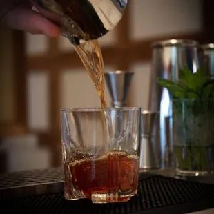 a person pouring a drink