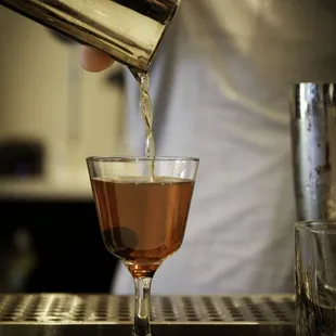 a bartender pouring a drink