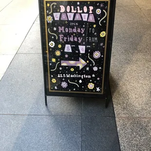 a sign on the sidewalk