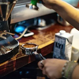 a person making a cup of coffee