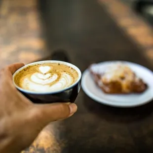 a person holding a cup of coffee