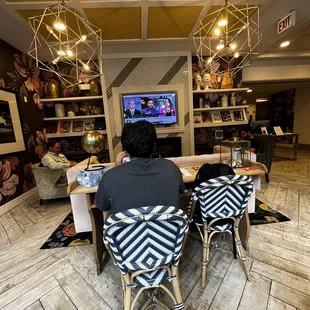 a person sitting at a table in a coffeehouse