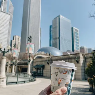 a hand holding a cup of coffee