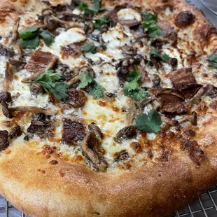 Mr Rager- garlic crema, goat cheese, mozzarella, bacon, mushrooms, cilantro