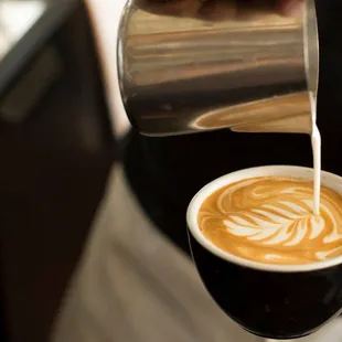 a bari serving a cup of coffee
