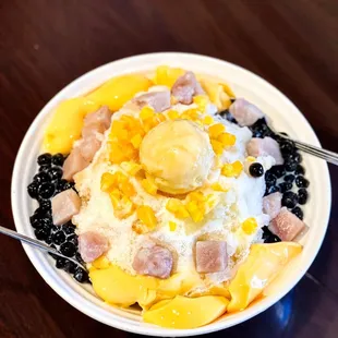 a bowl of fruit and ice cream