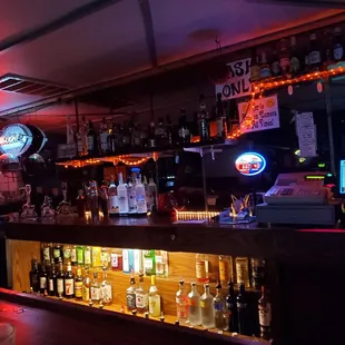 a bar with a lot of bottles of alcohol