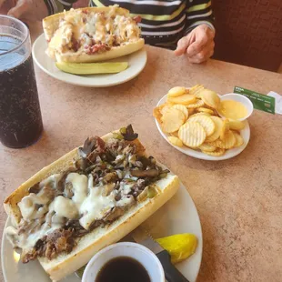 Gourmet shaved ribeye cheese steak, The Strami (rueben), and Olie&apos;s cottage fries with cheddar cheese sauce.