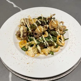 a plate of pasta with meat and vegetables