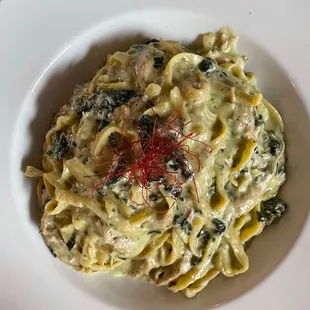 a plate of pasta with spinach