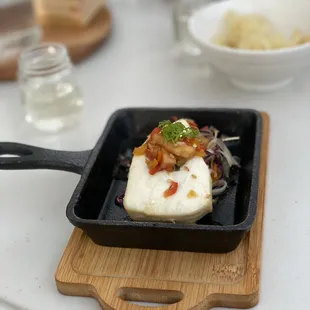 a pan of food on a cutting board