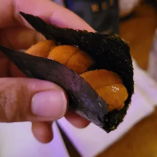 a person holding a piece of food