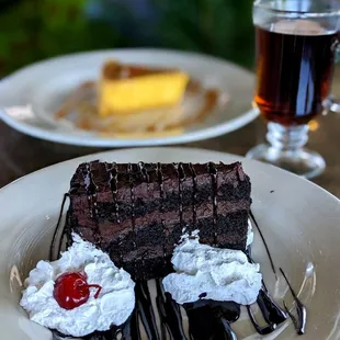  piece of chocolate cake with whipped cream and cherries