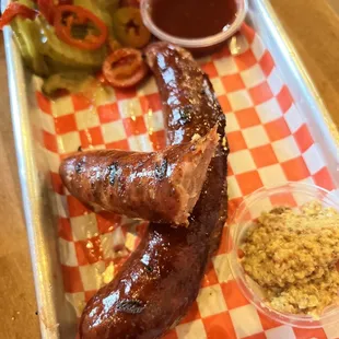 a tray of food with meat and sides