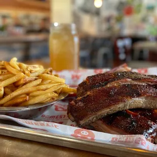 a plate of ribs and french fries