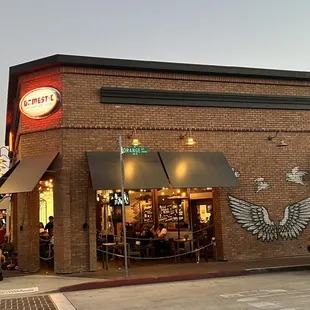 a brick building with a restaurant and a motorcycle parked in front of it