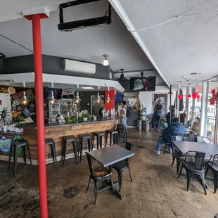 the inside of a restaurant with tables and chairs