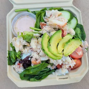 crab louie salad with hard boiled egg, rainbow tomatoes, cucumbers, avocado and citrus dressing