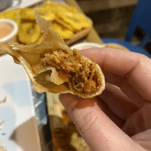 a hand holding a piece of food