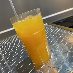 a glass of orange juice on a table
