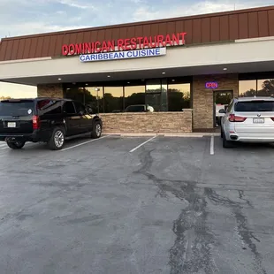 two cars parked in front of the restaurant