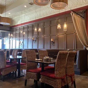 Dining room with comfortable high back chairs, beautiful wood paneling and high ceilings.  Very cold A/C.