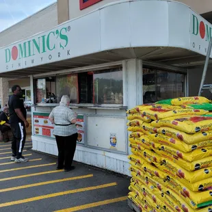 a man standing at a food stand