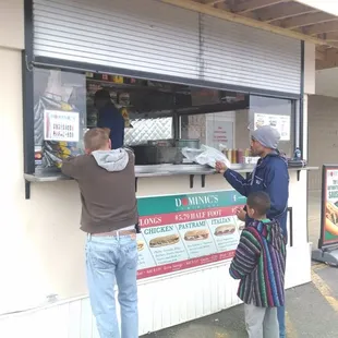 a man ordering food from a food truck