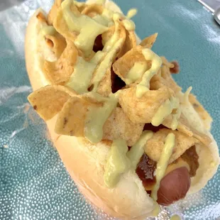 Bandito Hot Dog: Martin's Potato Roll, All-Beef Hot Dog, Melted Cheese, Chili, Fritos, and Jalapeño Sauce