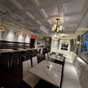 a dining area with tables and chairs