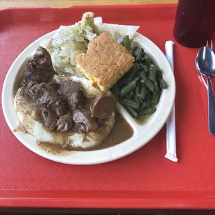Pork stew over mashed potatoes, cabbage, green beans, and cornbread! Excellent!