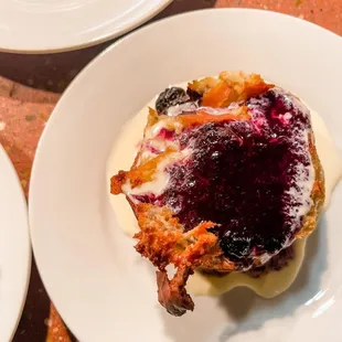 *menu item* blue berry bread pudding with crème anglaise and blueberry compote.