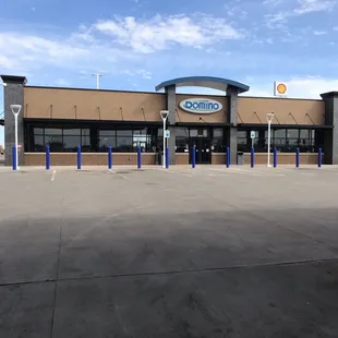 the outside of a building with a parking lot in front of it