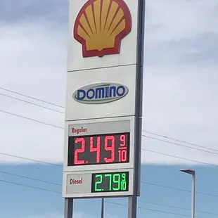 a gas station sign with a shell sign in the background