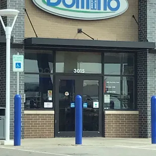 the entrance to a domino store