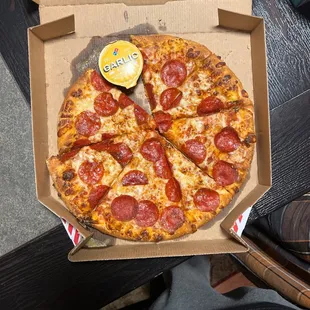 a pepperoni pizza in a box