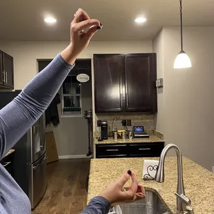 a woman reaching for a piece of pizza