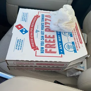 a pizza box in the back seat of a car