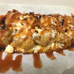 a piece of pizza covered in caramel sauce