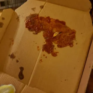 The box was slightly crushed; leaving this excess hot sauce on the inside of the box.