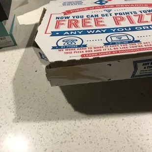 a box of pizza sitting on a counter