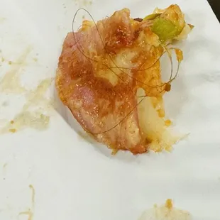 a half eaten pizza on a paper plate