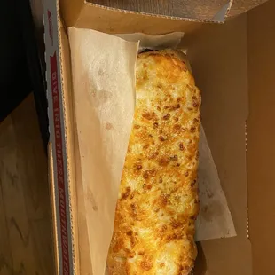 a slice of cheese pizza in a box