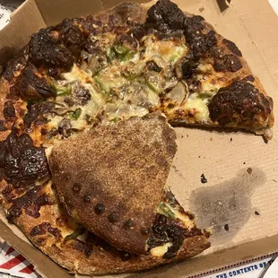 a half eaten pizza in a box