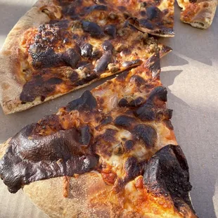 The pizza Domino's "burnt to a crisp" that went straight to the garbage. Owner/manager refused to refund.