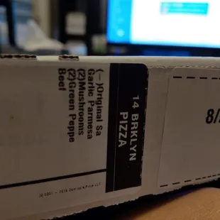 a person holding a box of pizza