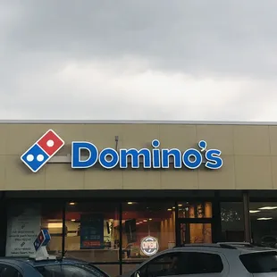 two cars parked in front of the store